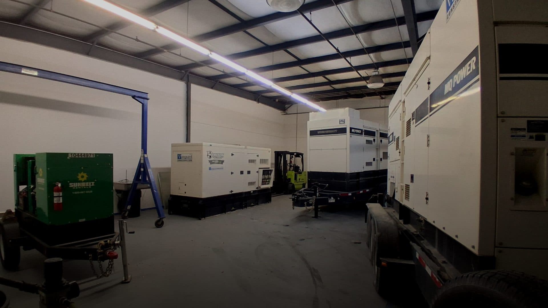 Generator fleet staged in warehouse with MQ Power and Sunbelt rental units ready for deployment